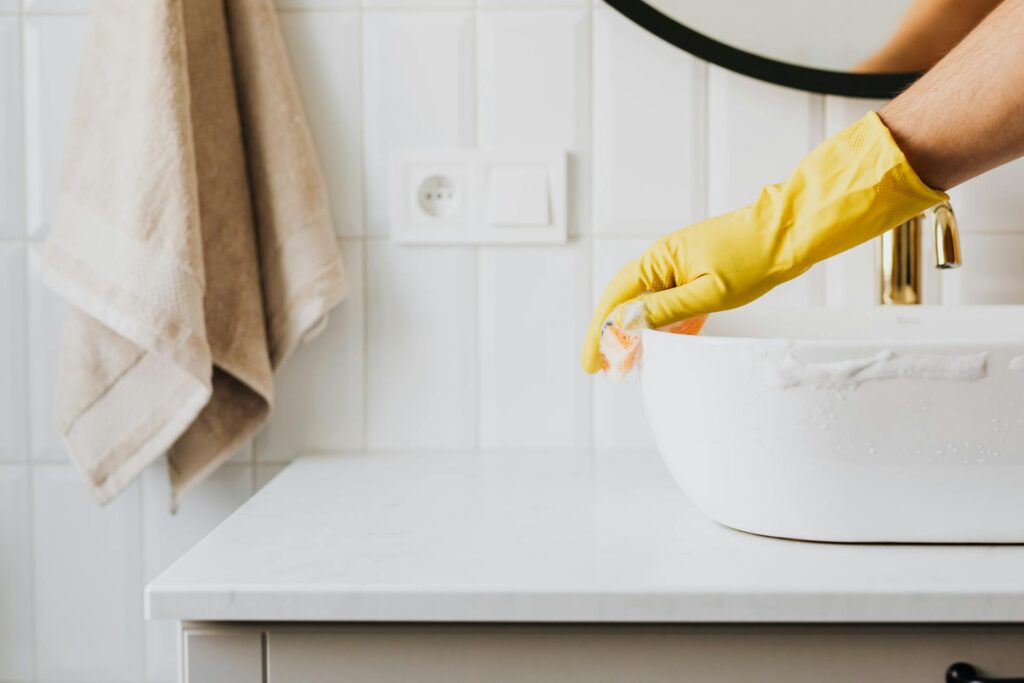 hand cleaning a sink