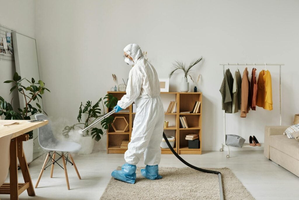 woman on a protective gear cleaning a chair
