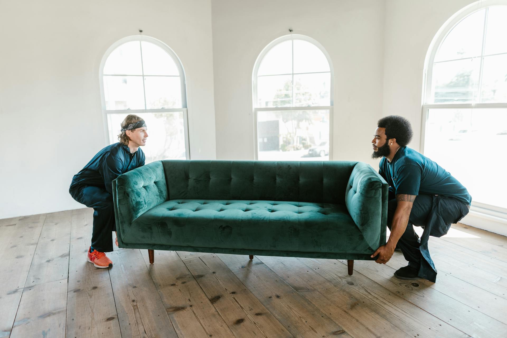2 men lifting a couch